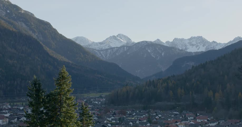 Red roofed white walled buildings in valley between mountains