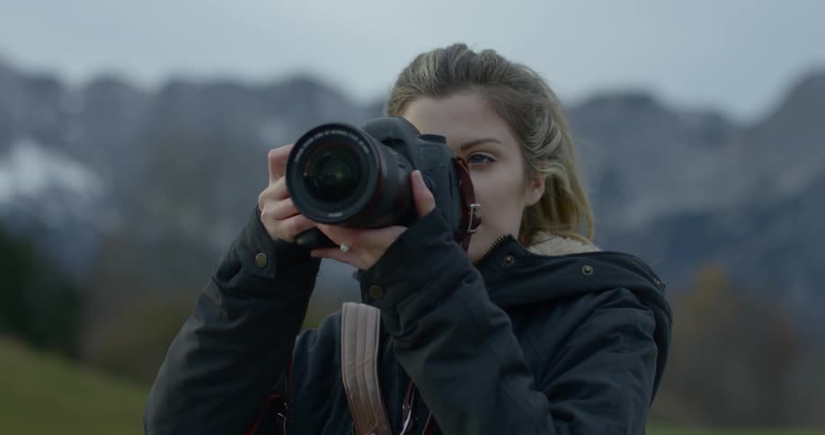 A woman raises her camera