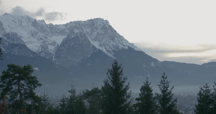 A snowy mountain peak rises into the sky