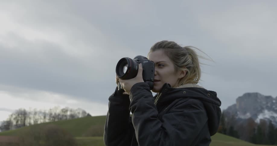 A female photographer at the grassland
