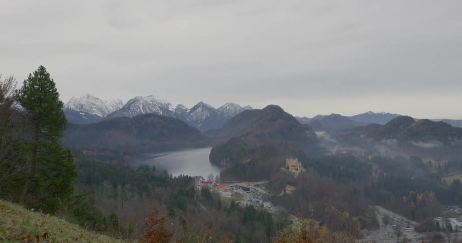 A small town sits in a valley near a body of water