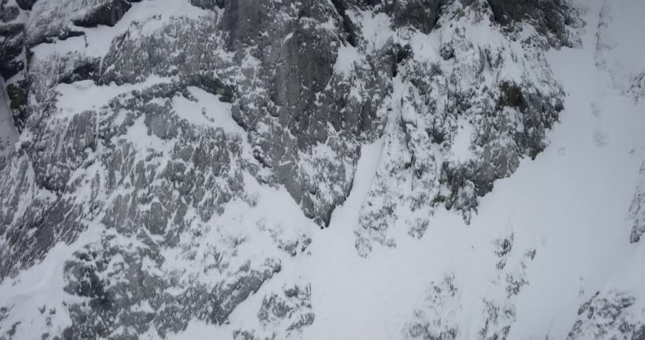 Snow covers the side of a mountain