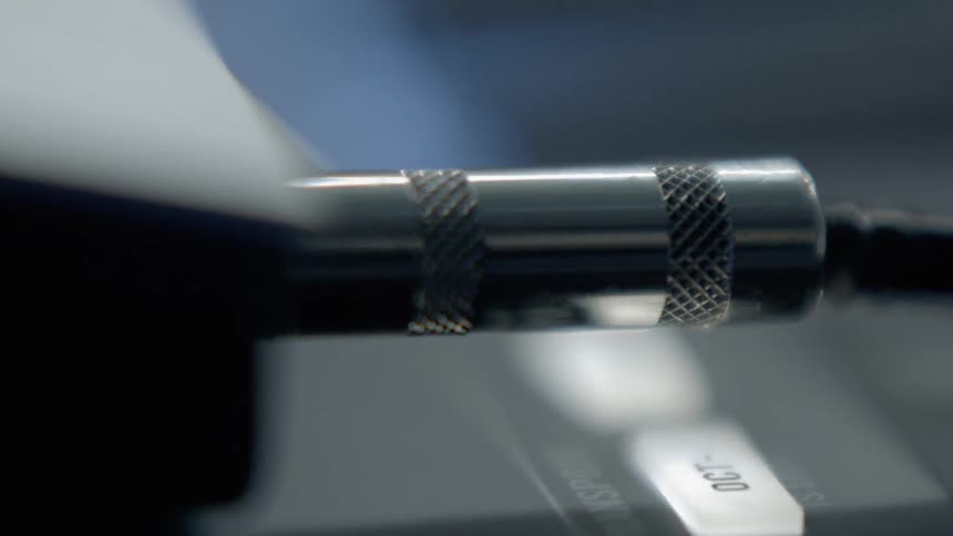 A person unplugs an audio jack