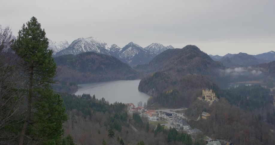 Landscape view of buildings at the shore of the water with the mountains in the background