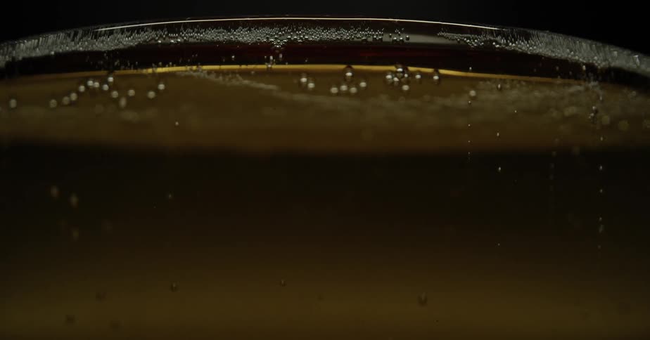 Bubbles floating to the surface in a glass