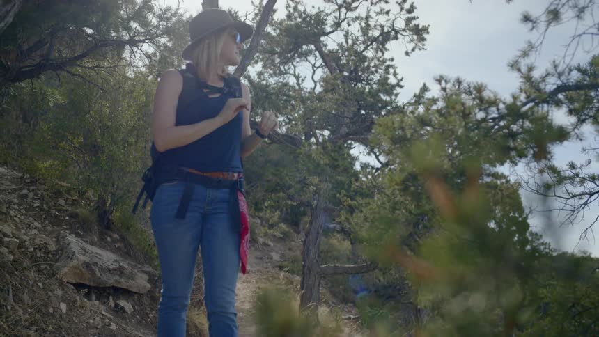 A woman is hiking outdoors