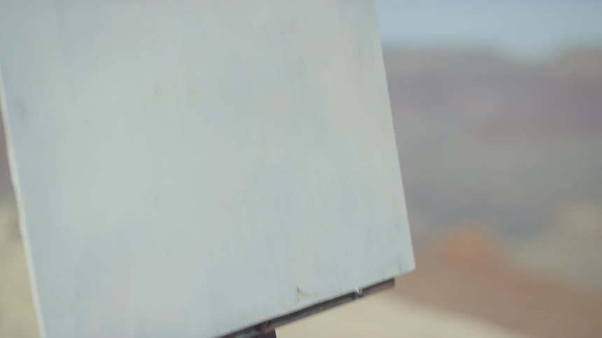 A person adjusting an outdoor easel