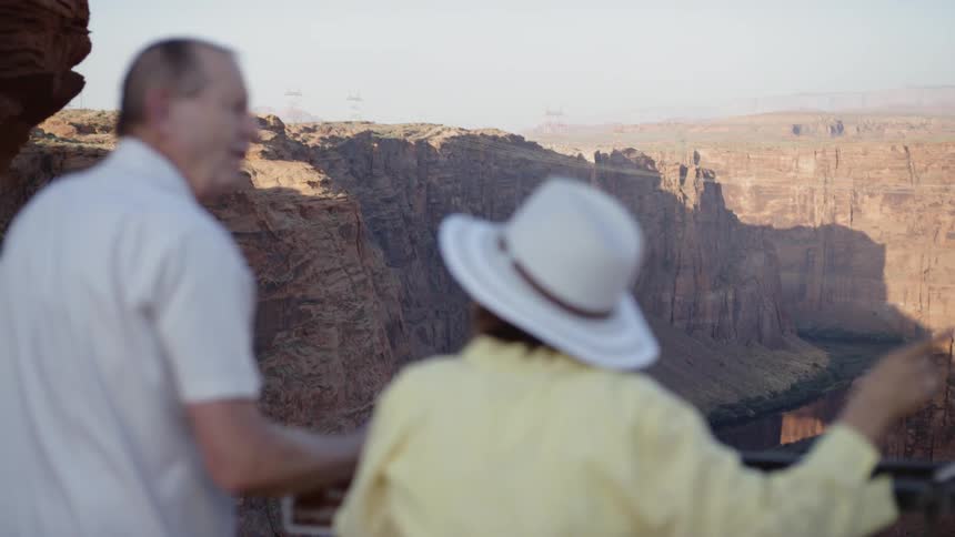 Older couple admiring the grand canyon from the railing