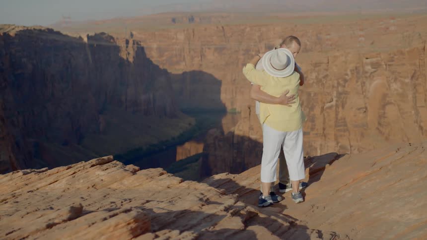 Husband and wife are holding hands while hiking