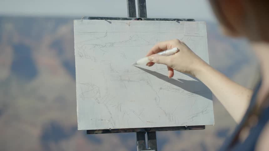 Woman sketching the canyon on an easel