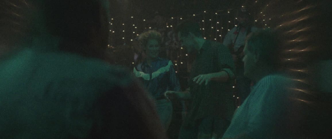 A woman and man dance together in a night club