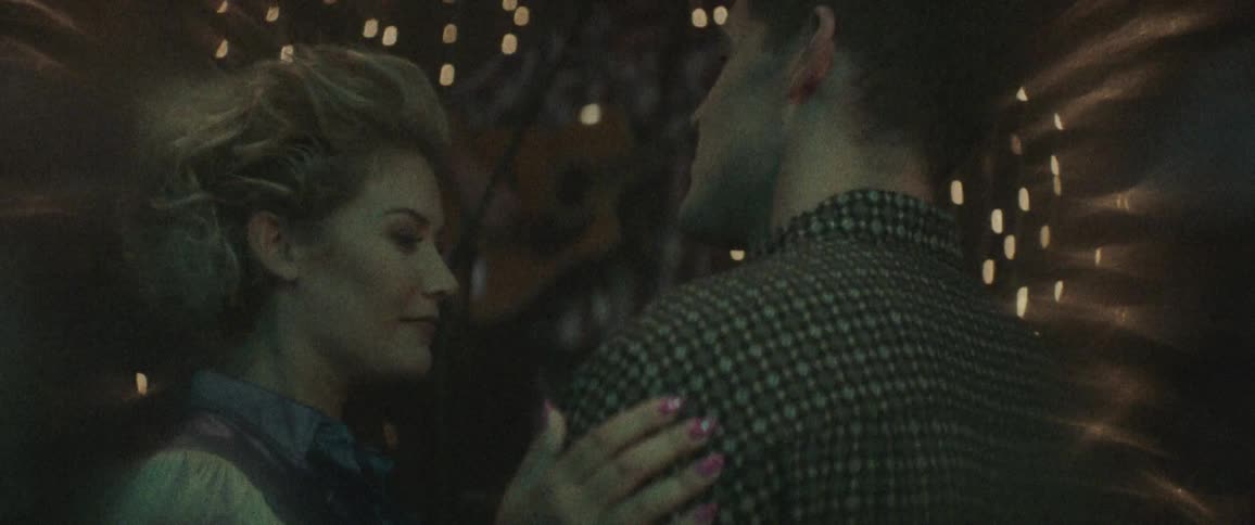 A man and a woman in a nightclub dancing