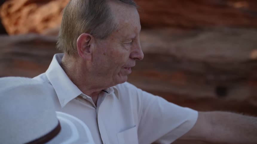 An elderly woman and man looking out over a canyon
