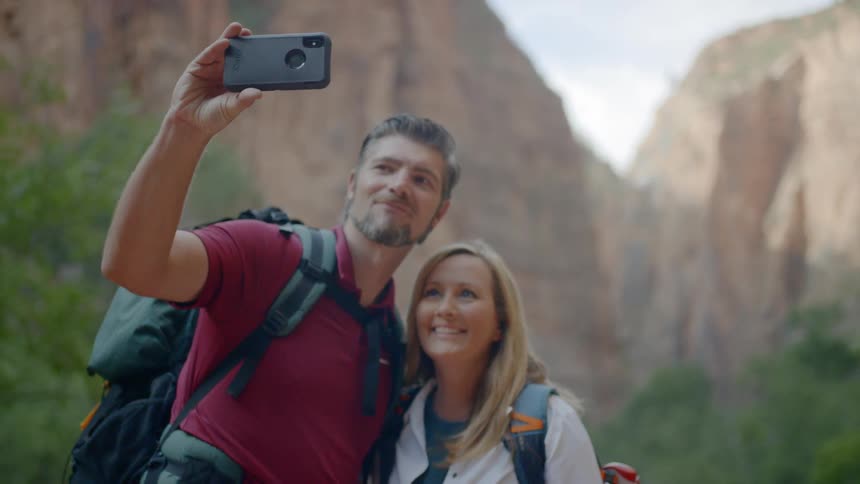 Man and woman take selfie while out hiking