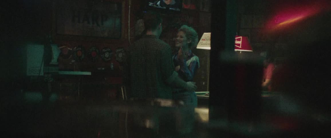 People have fun in a bar playing pool and dancing