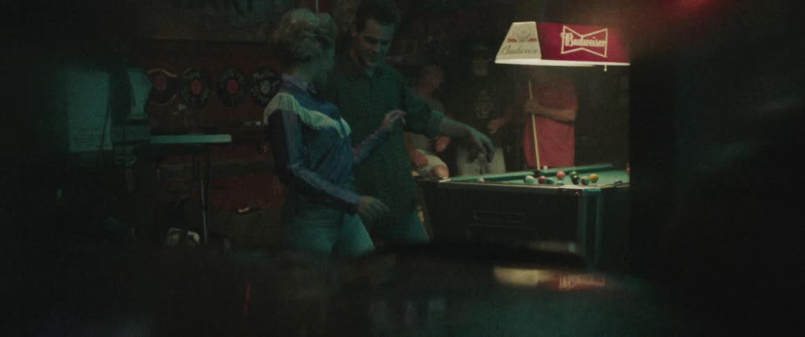 People are in a bar and dancing