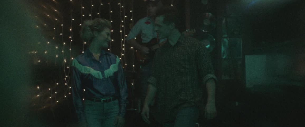 A man and woman talk on the dance floor