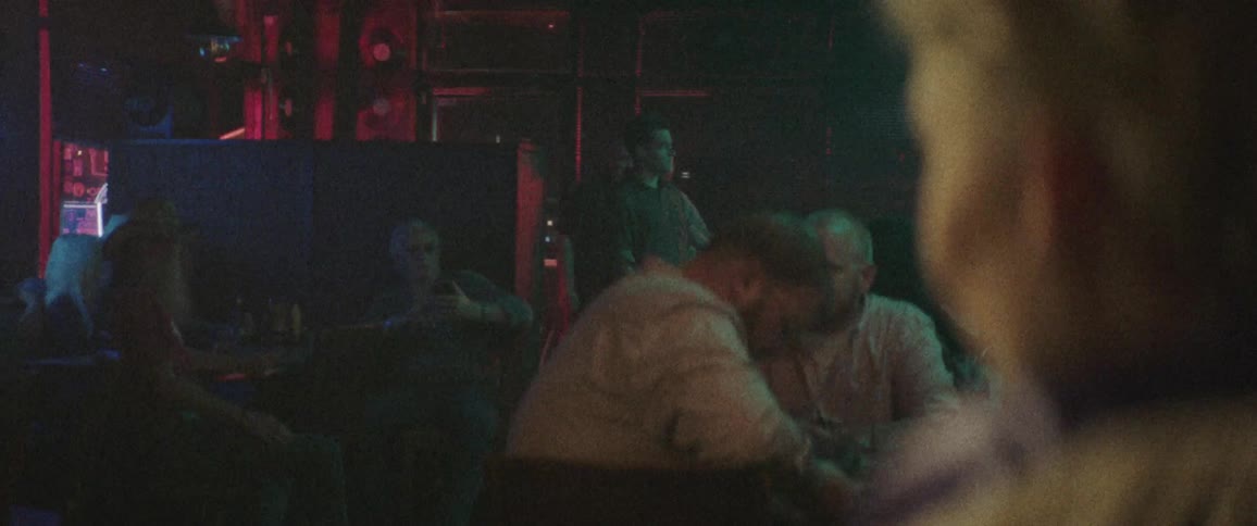 A group of people watching a performance in a night club