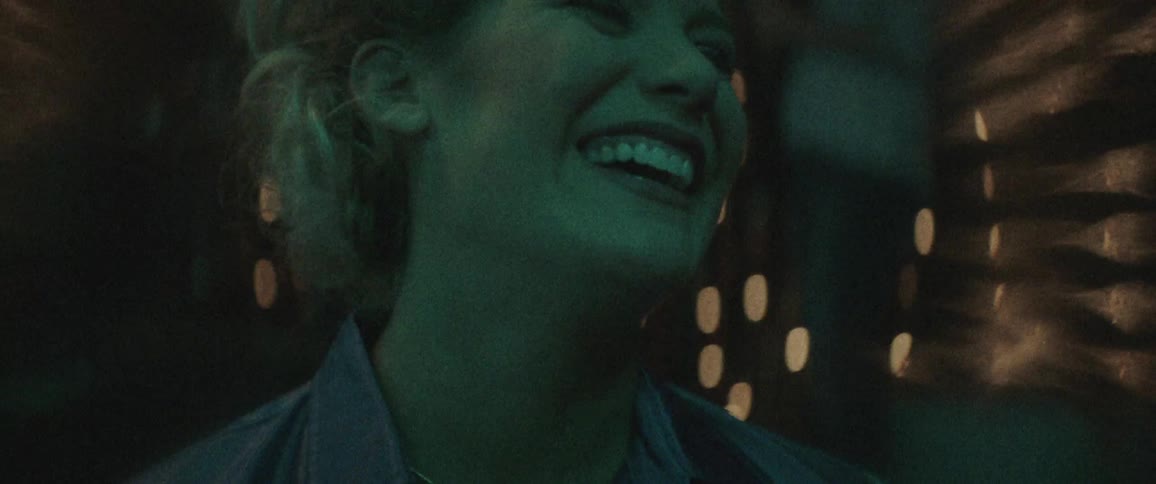 A woman is talking and laughing at night