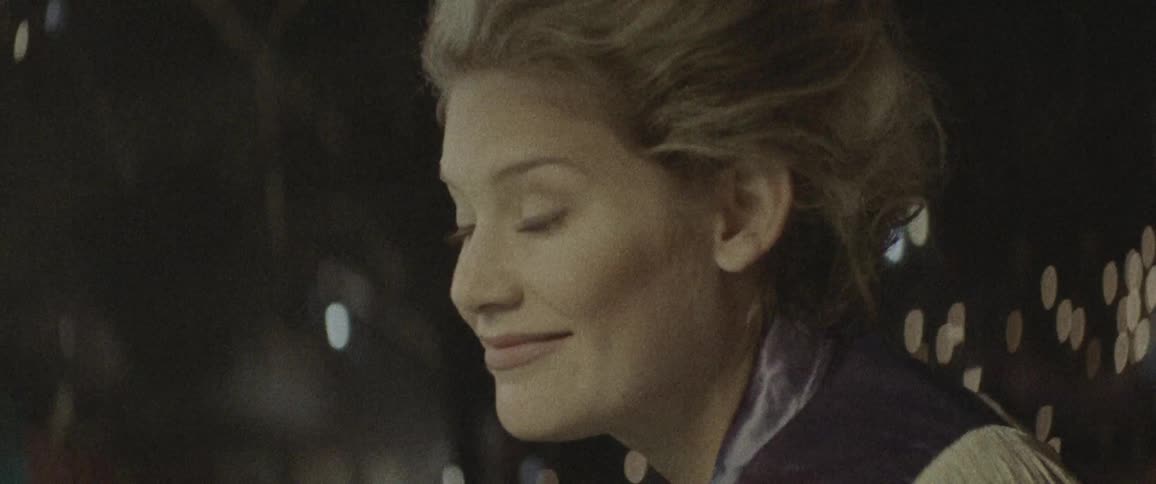 A woman smiles and blinks