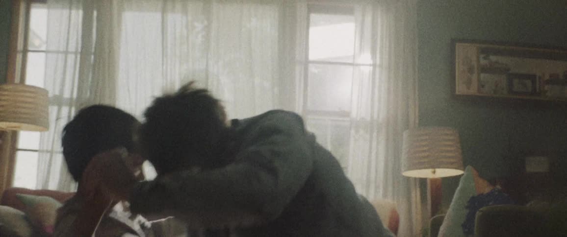 A father plays with his sun by the window