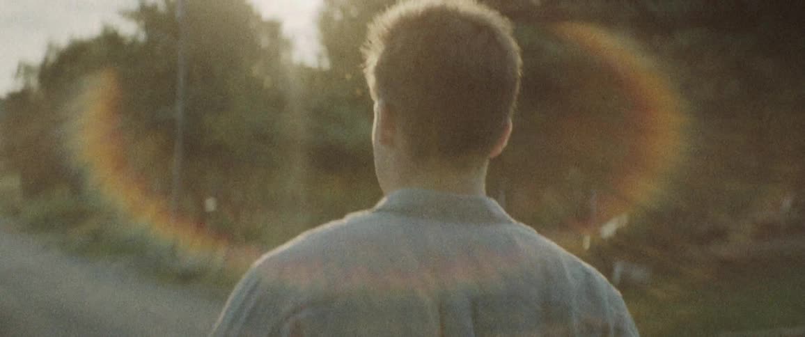 A man is walking down the rural road