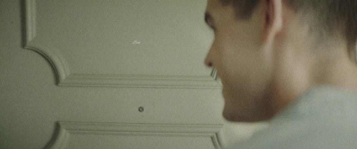 A man knocks on a door which is opened by a smiling woman