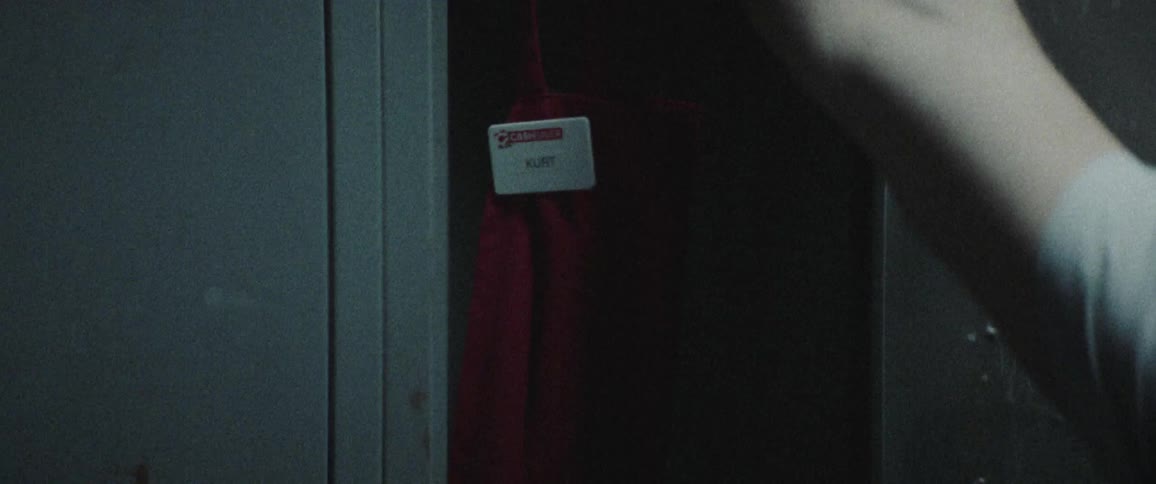 A person opens the locker and takes out an apron