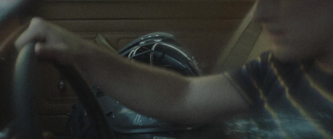 Man holds on to a steering wheel as he sits in a vehicle