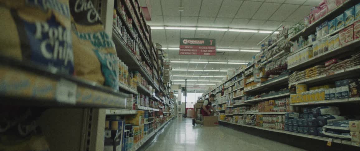 A worker in a supermarket stocking shelves