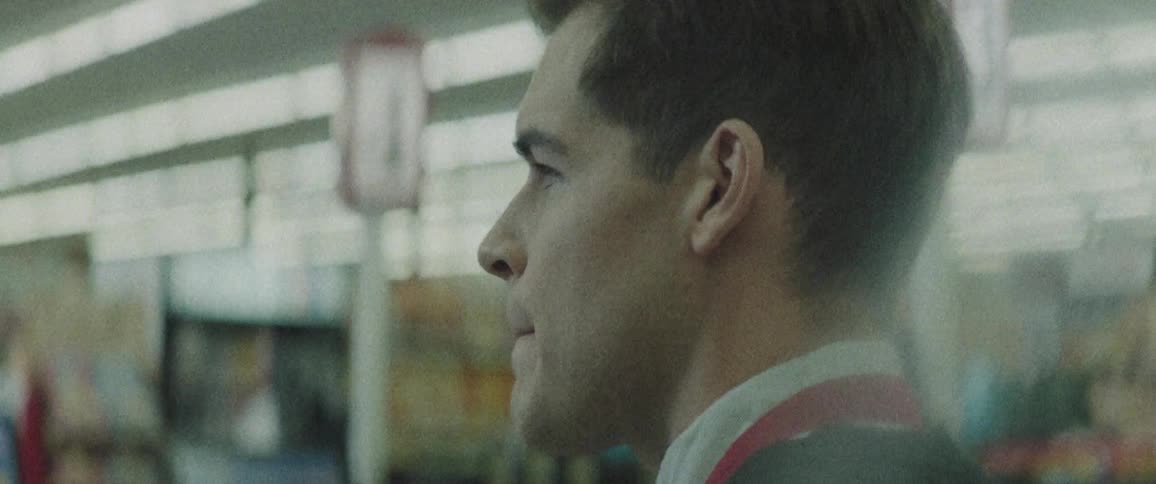 A store clerk stands in a store and stares into the distance