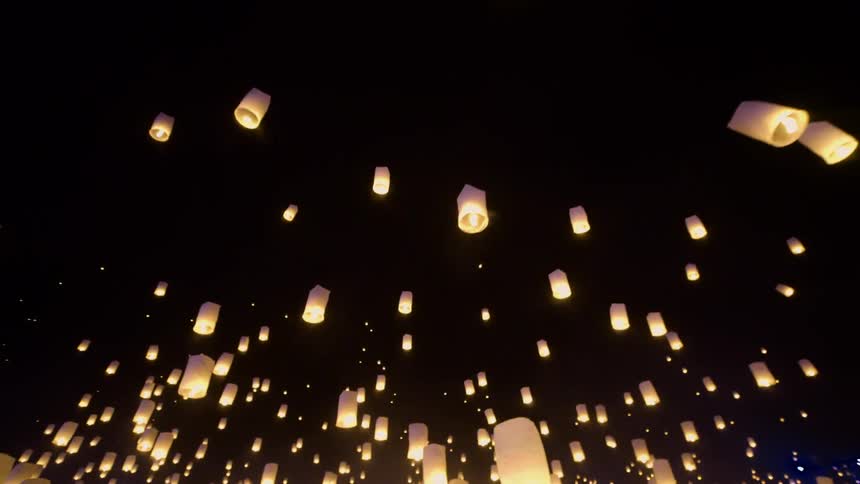 Cloth fire lamps are rising into a night sky