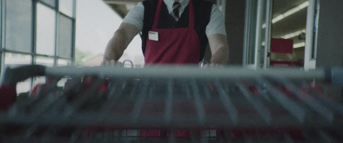 An employee is pushing carts