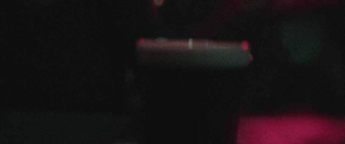 A glass of beer is pushed across the table