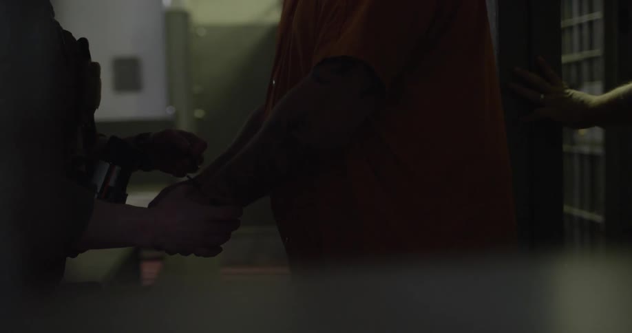 A prisoner exits a prison cell