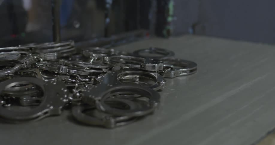 A pile of handcuffs on a table