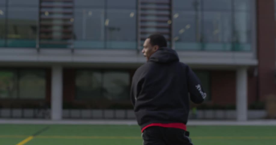 A man catches and throws a football