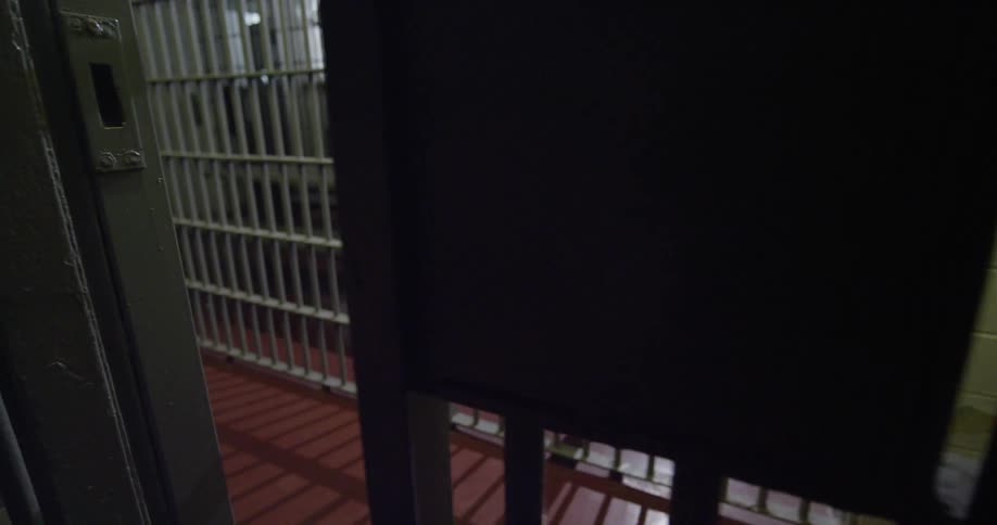 A guard opening up a prison cell