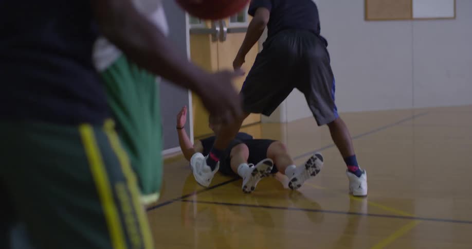 People playing basketball indoors