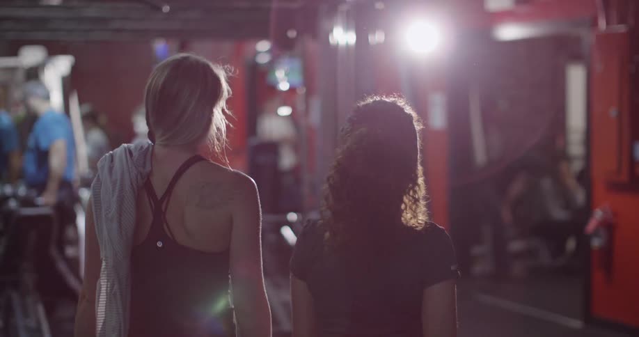 Two women high five in a gym