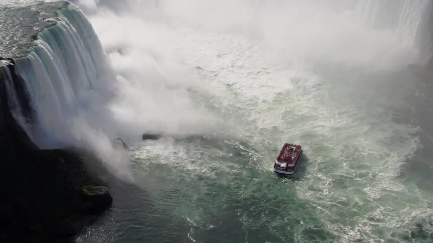 Aerial of a tour boat leaving horseshoe falls at niagra falls