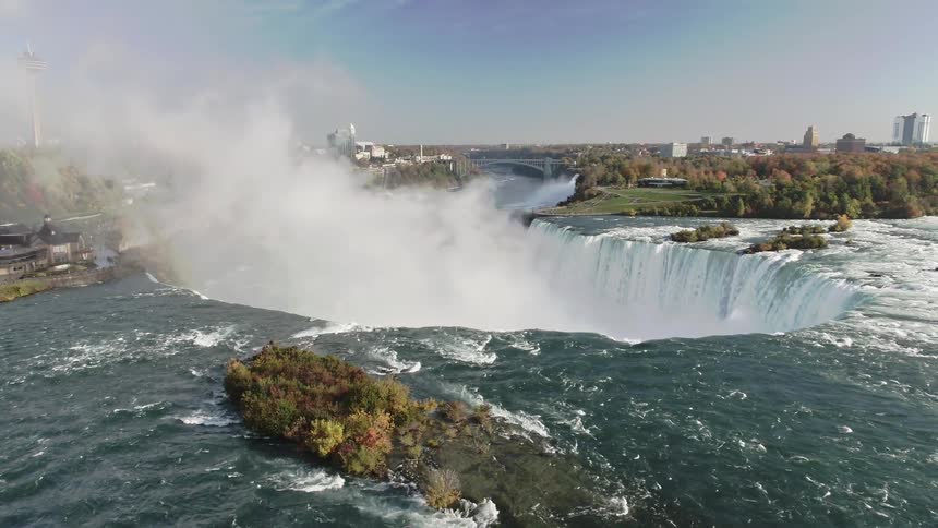 An aerial view of a waterfall and lake