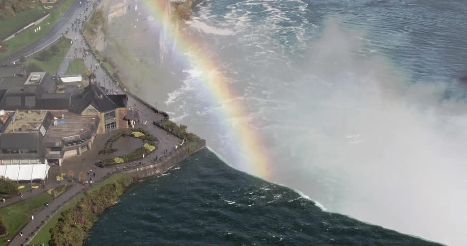 A rainbow with a large mist behind it
