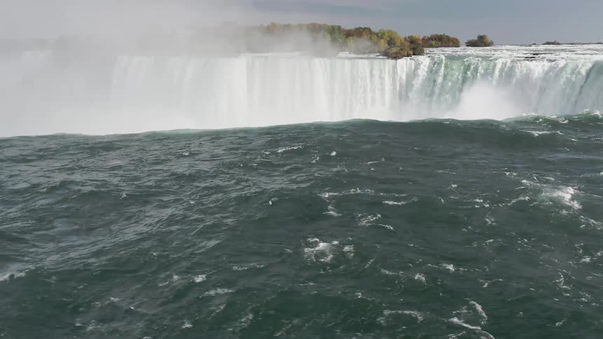 A waterfall crashes in to the water below