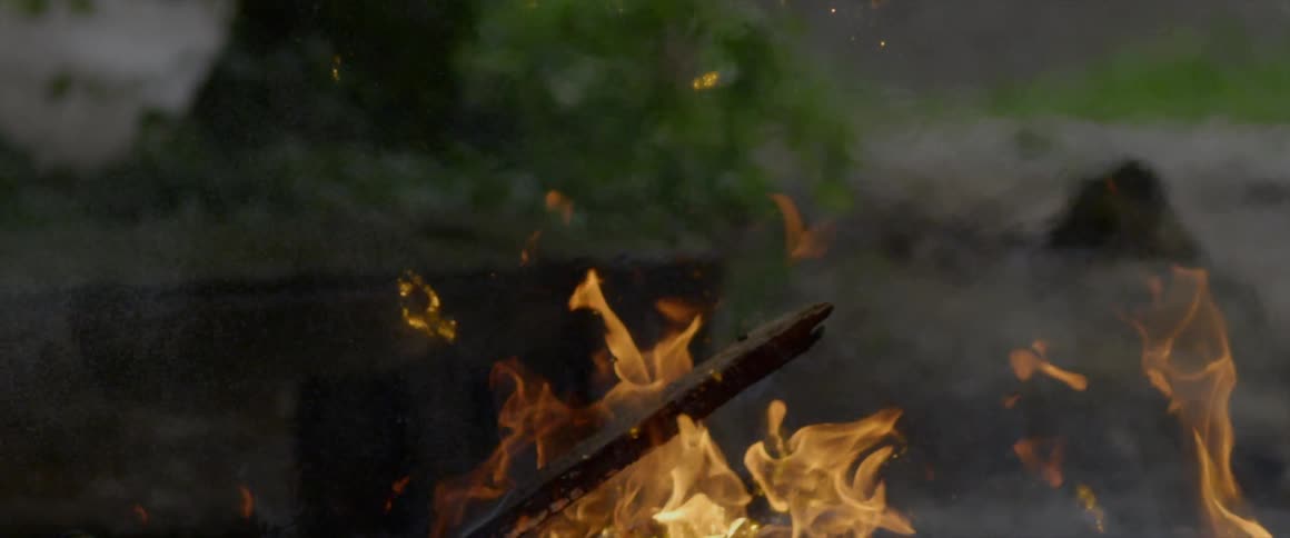 A fire burns outdoors