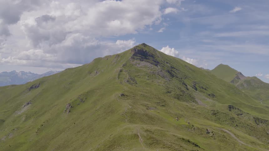 Clouds are high in the sky above the mountains