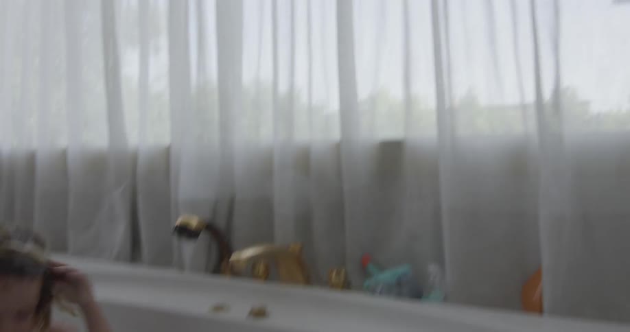 Toddlers taking a foamy bath in a bathtub