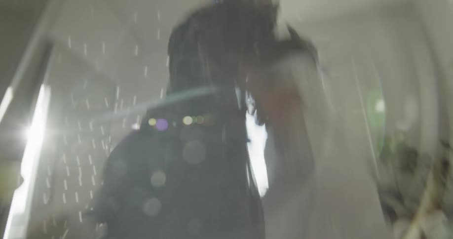 A girl in a night gown playing with fabrics in a room with a disco ball