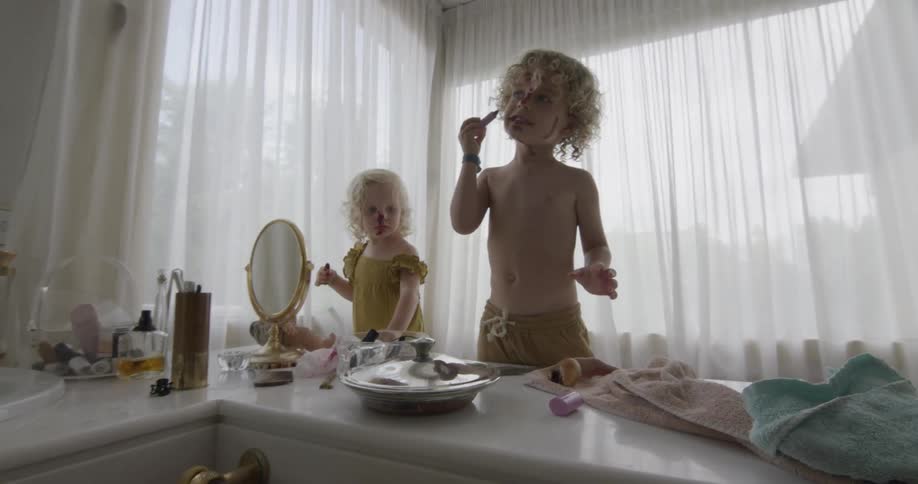 Toddlers playing with makeup in a room