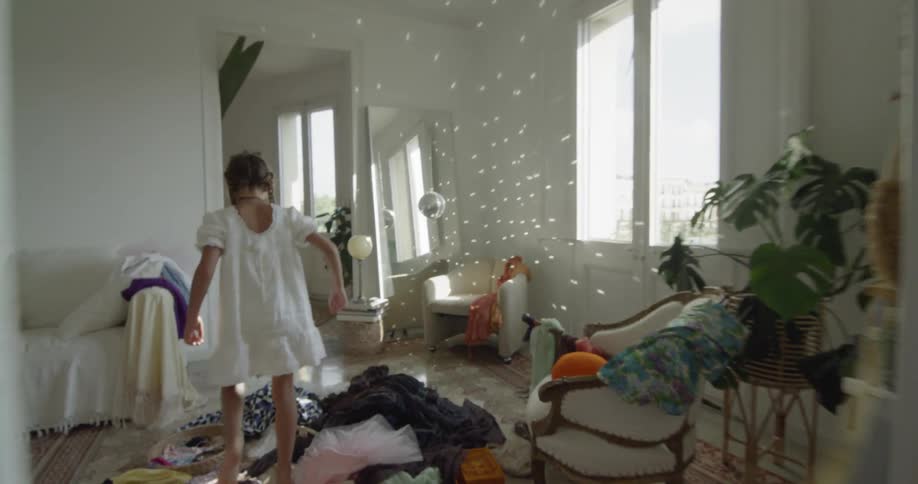 A girl runs through a house